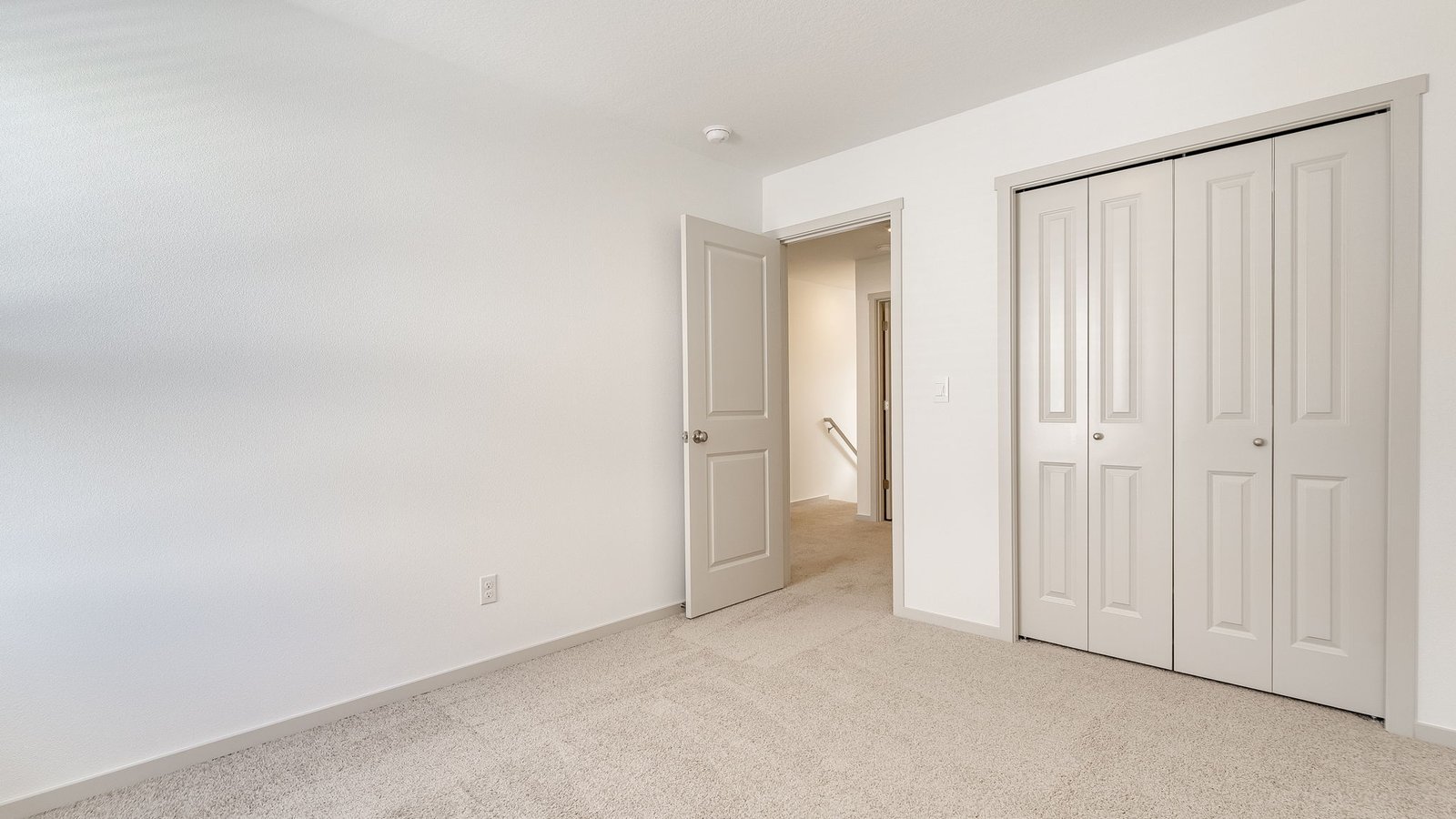 Bedroom with wall-to-wall carpet and a closet