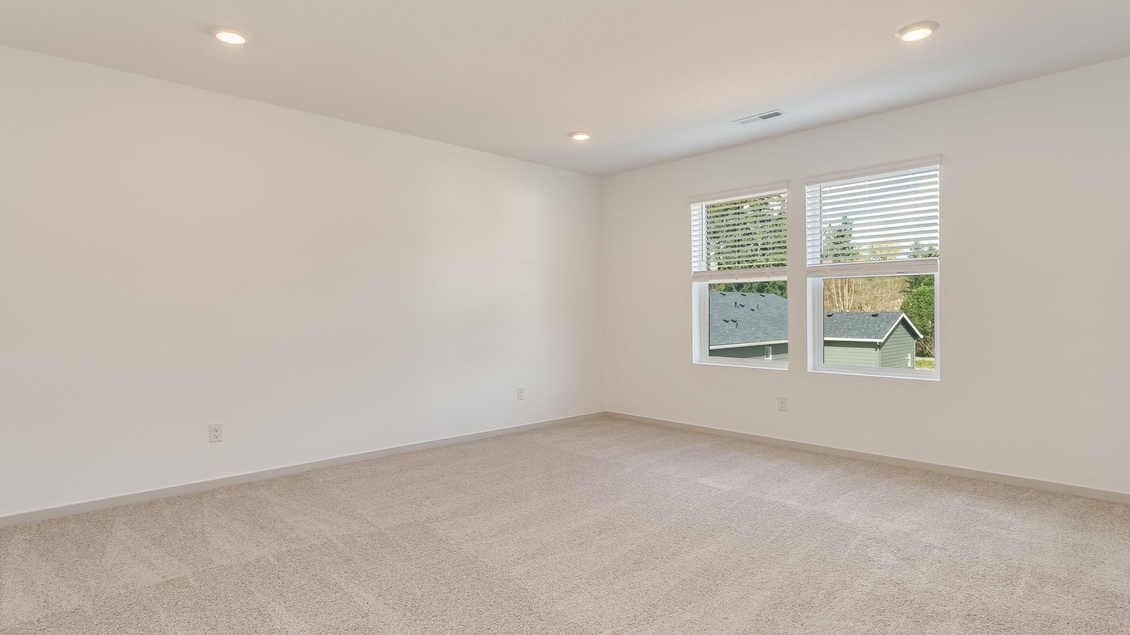 Primary bedroom with wall-to-wall carpet, a walk-in closet and an attached bathroom