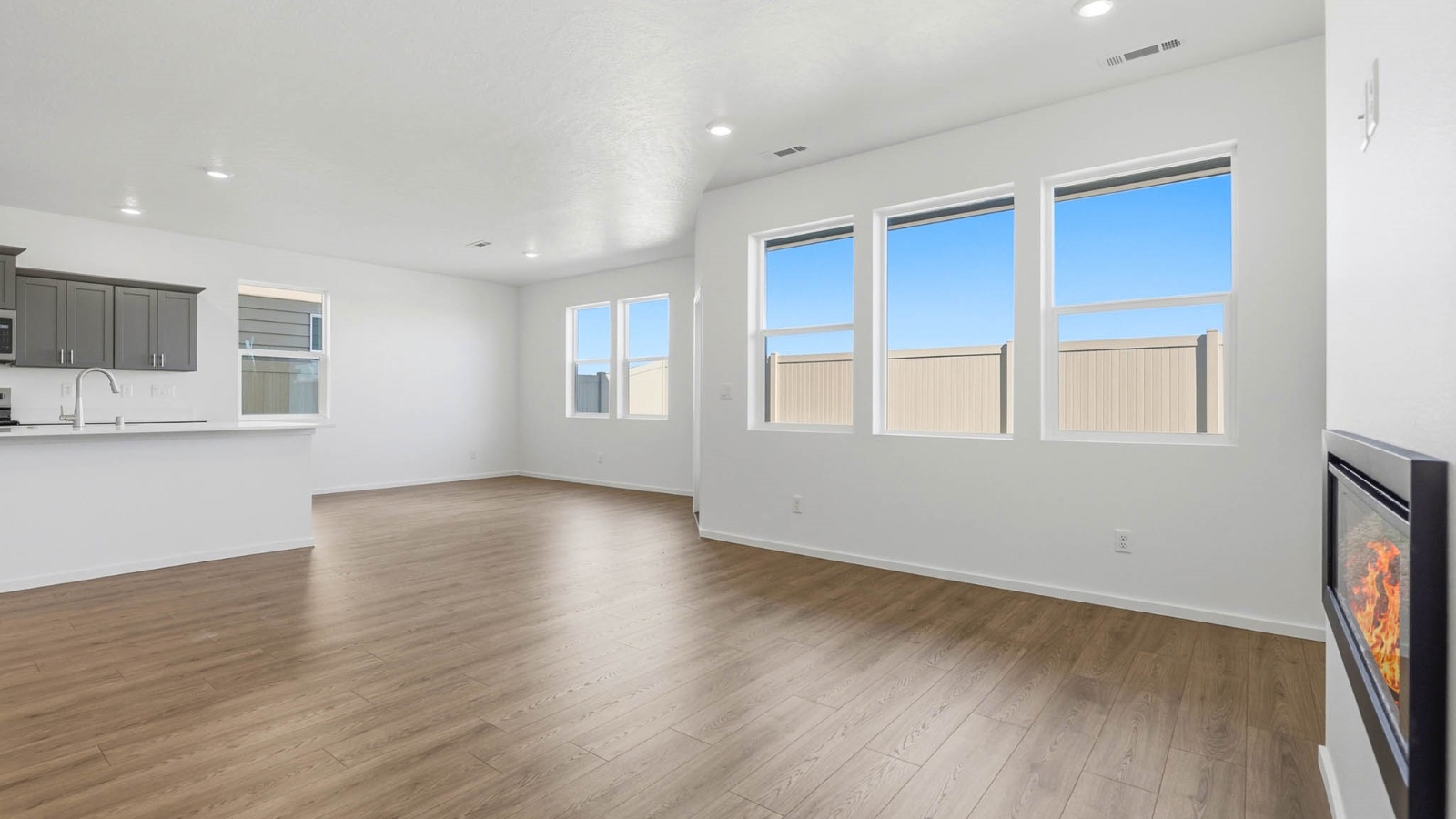 Great room with laminate flooring and an electric fireplace