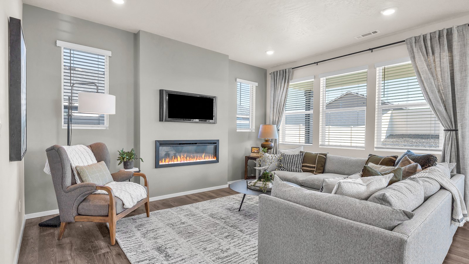 Great room with laminate flooring and an electric fireplace