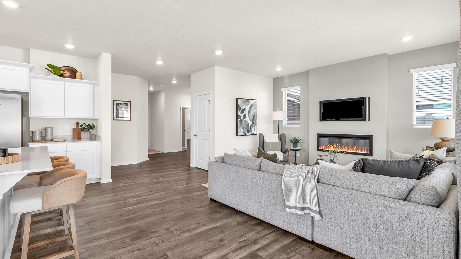 Great room with laminate flooring and an electric fireplace