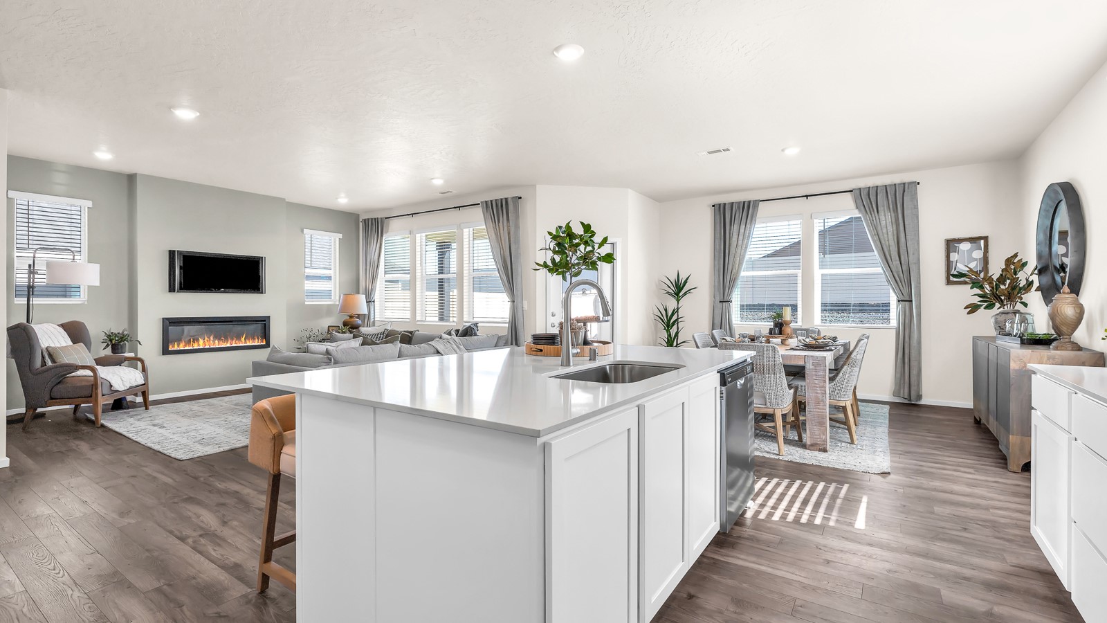 Kitchen with shaker cabinets, quartz counters, stainless steel appliances, pantry, and an island with a breakfast bar