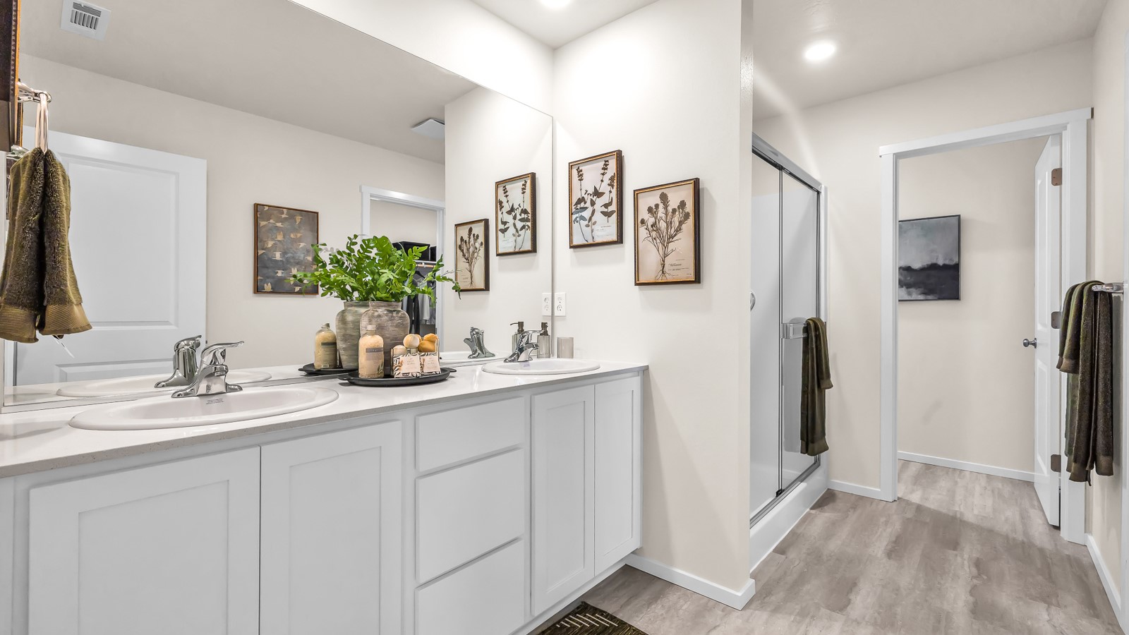 Primary bathroom with quartz counters and a walk-in shower