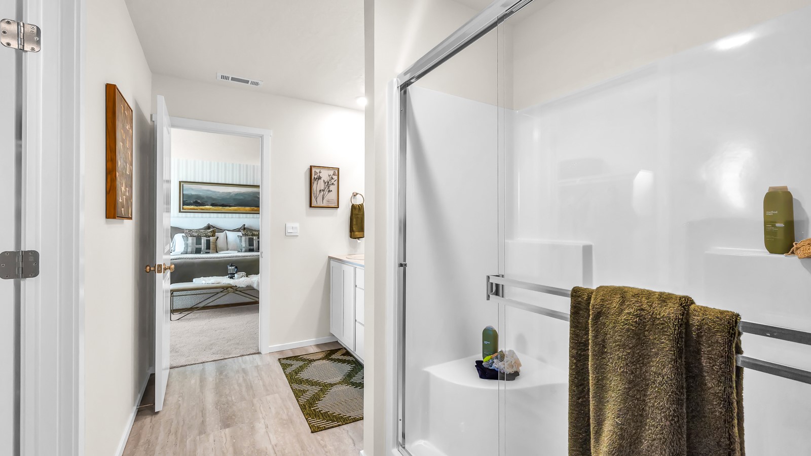 Primary bathroom with quartz counters and a walk-in shower
