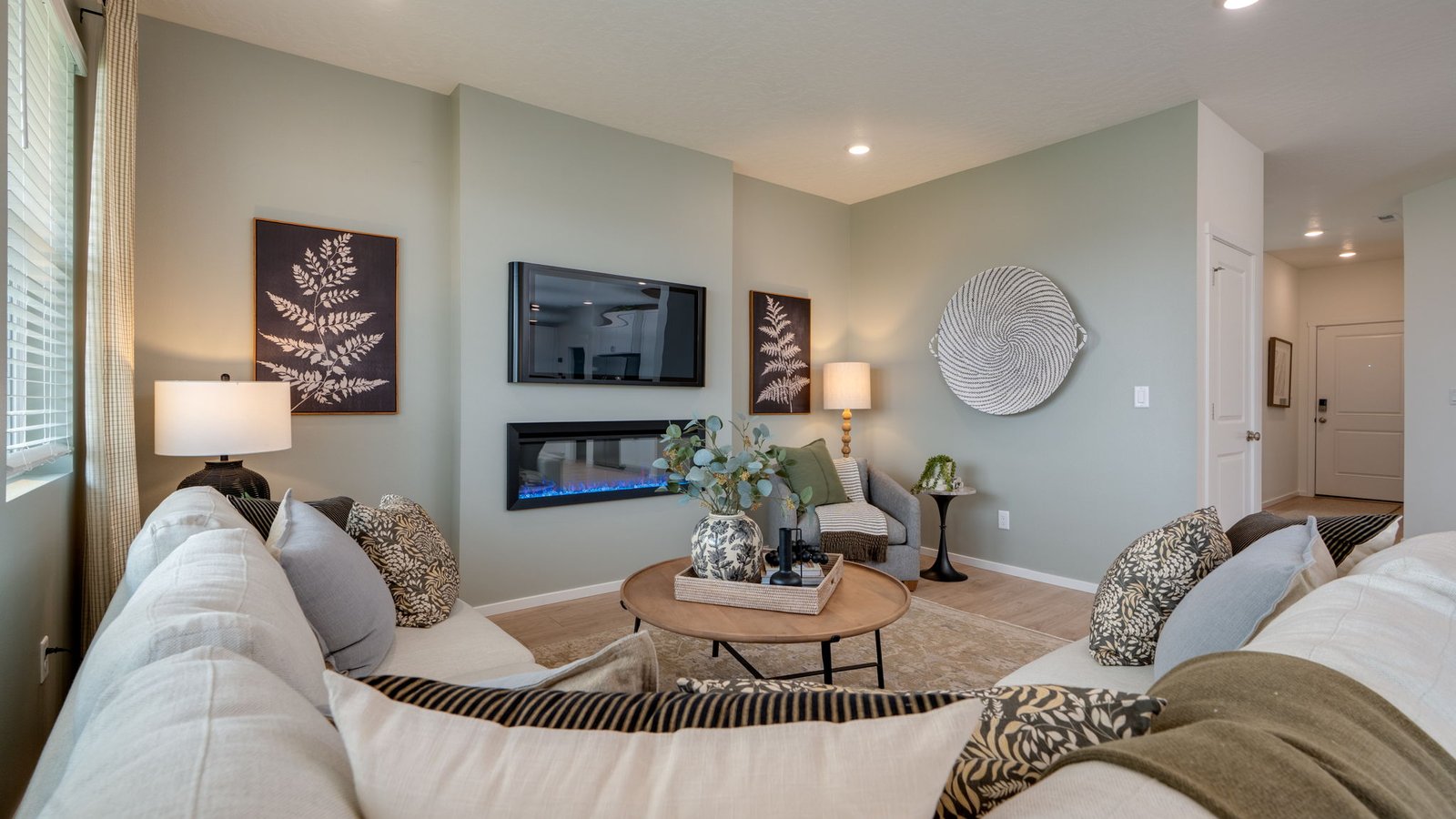 Great room with laminate flooring and an electric fireplace