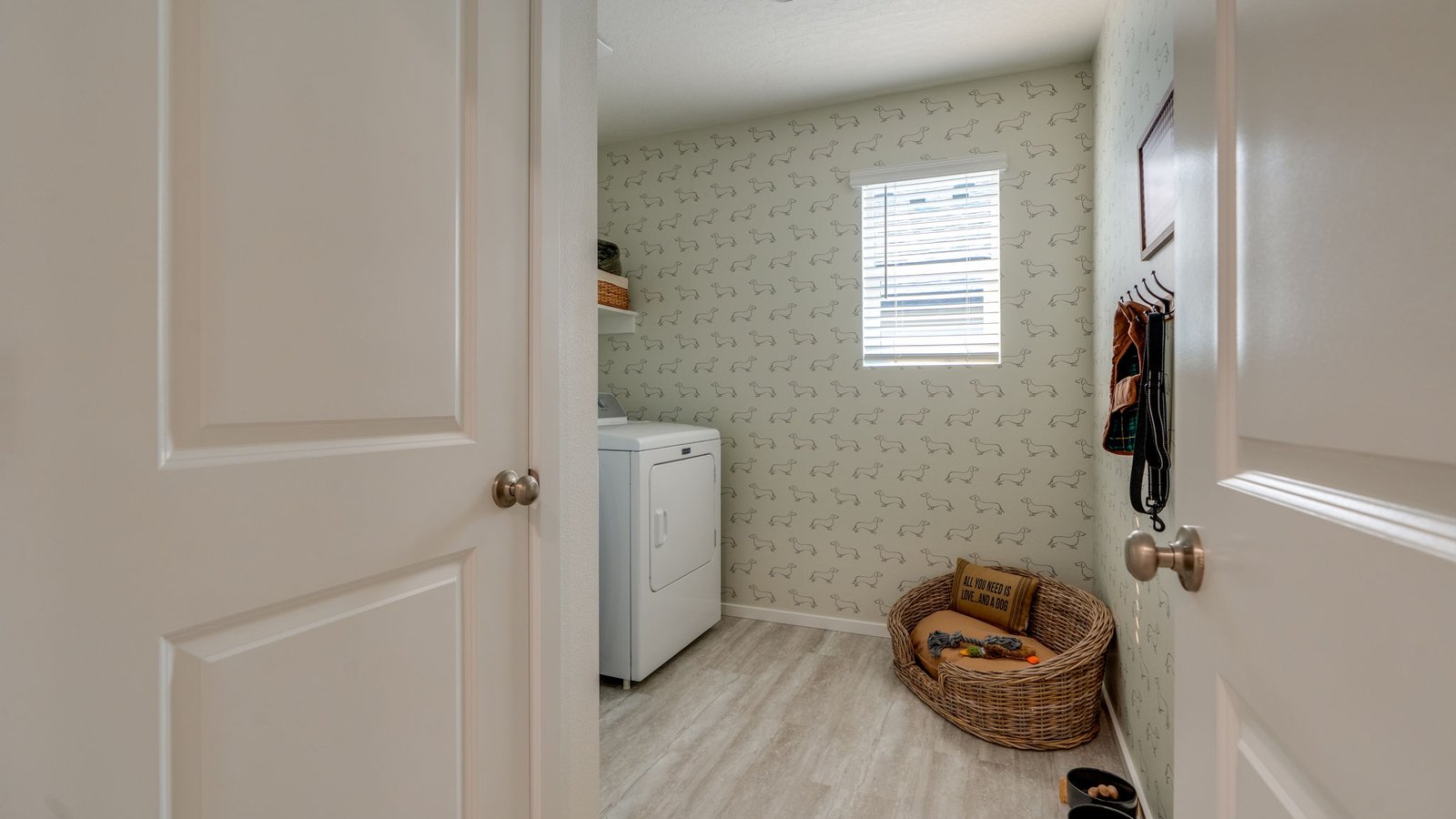 Laundry room with built-in shelves and washer and dryer hookups