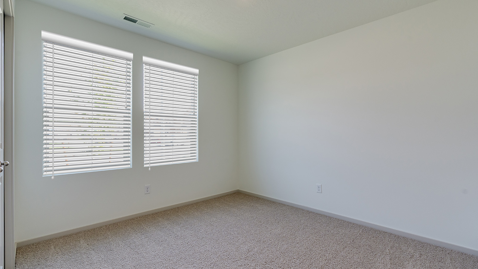 Bedroom with wall-to-wall carpet and a closet