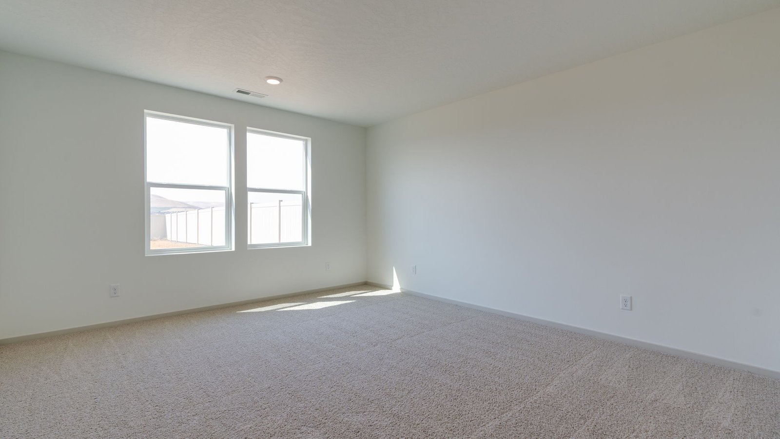 Primary bedroom with wall-to-wall carpet, a walk-in closet and an attached bathroom
