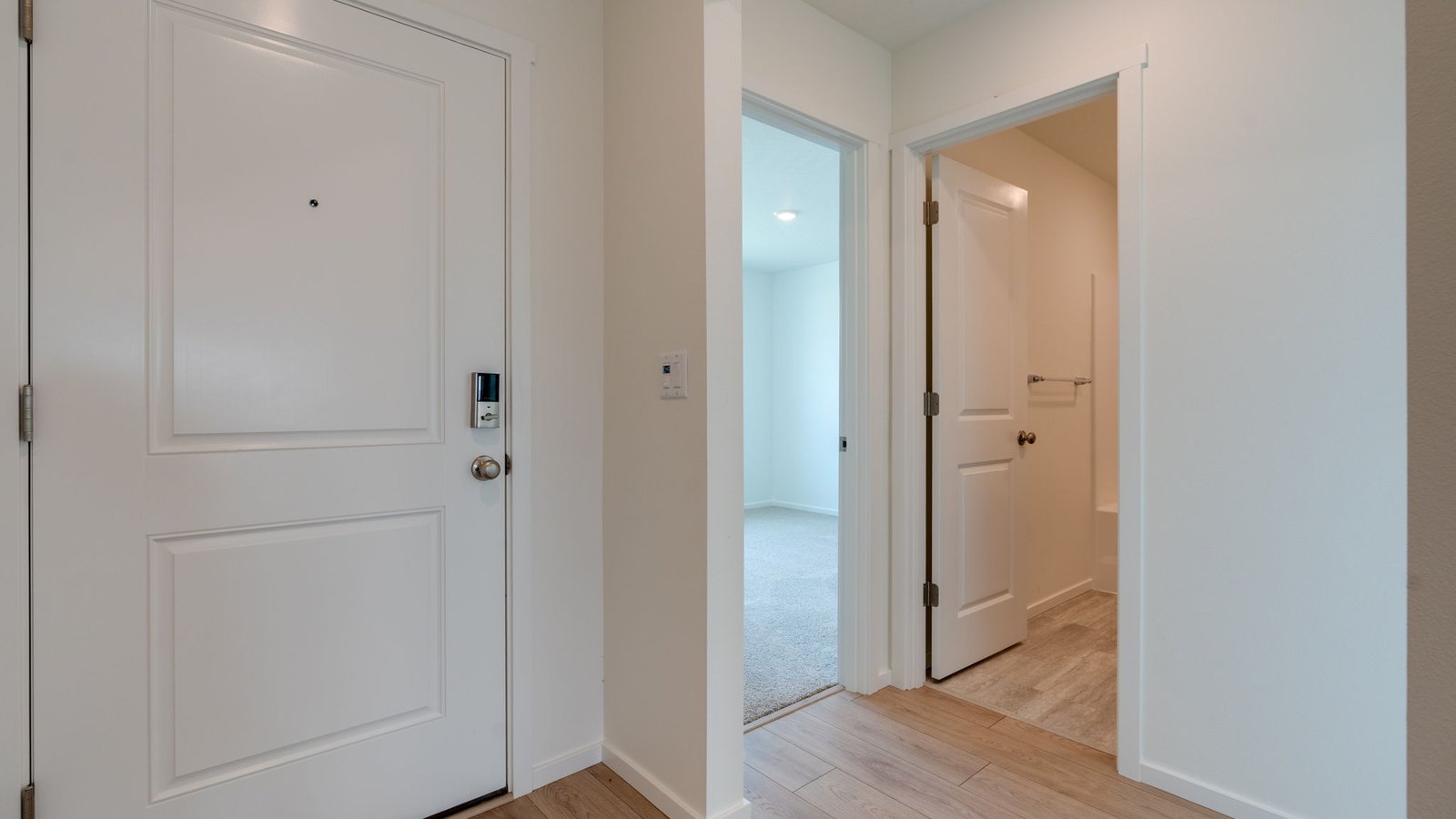 Entryway with a coat closet and laminate flooring