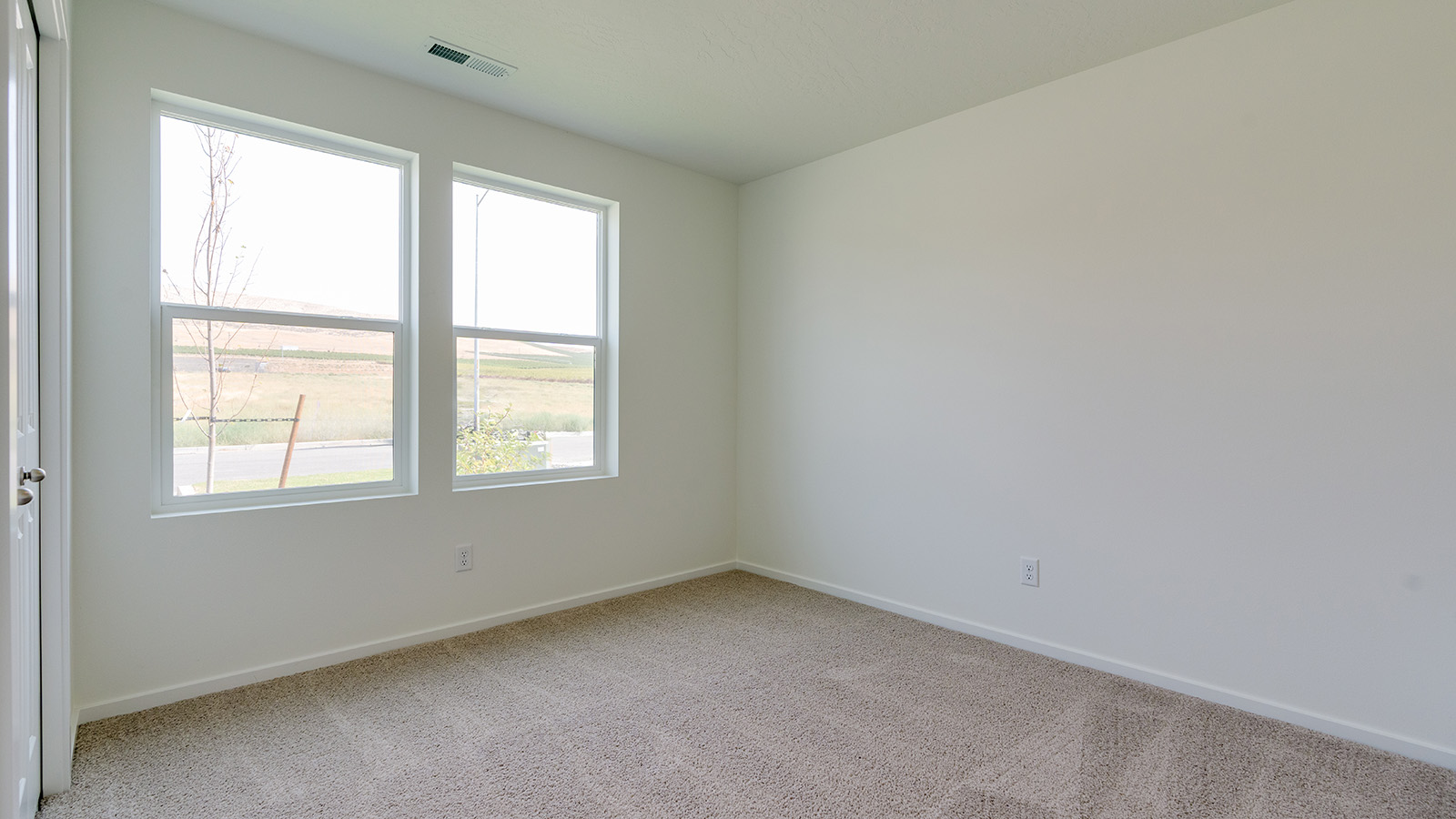 Bedroom with wall-to-wall carpet and a closet
