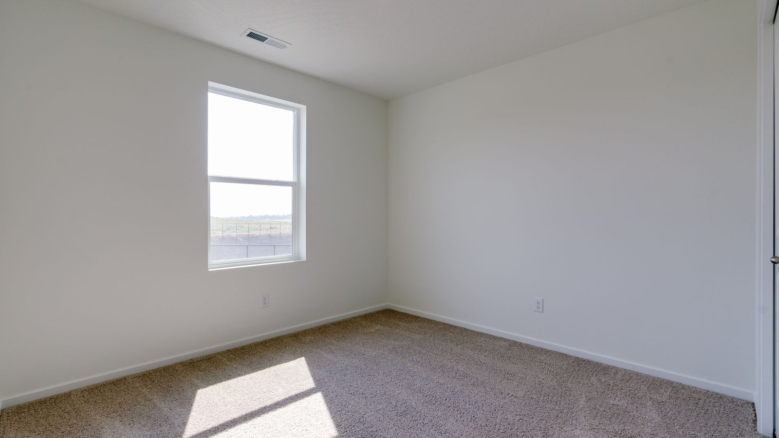 Bedroom with wall-to-wall carpet and a closet