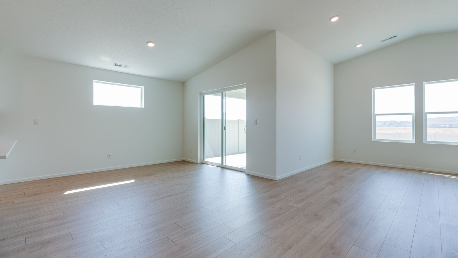 Dining area with a sliding glass door to a fenced backyard