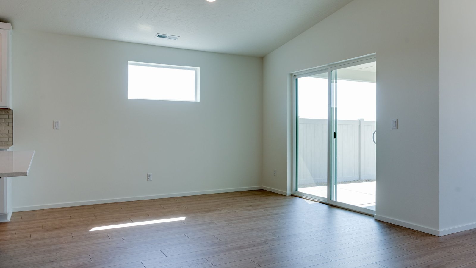 Dining area with a sliding glass door to a fenced backyard