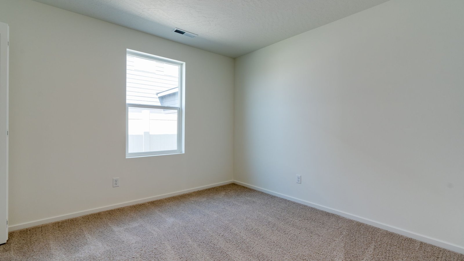 Bedroom with wall-to-wall carpet and a closet