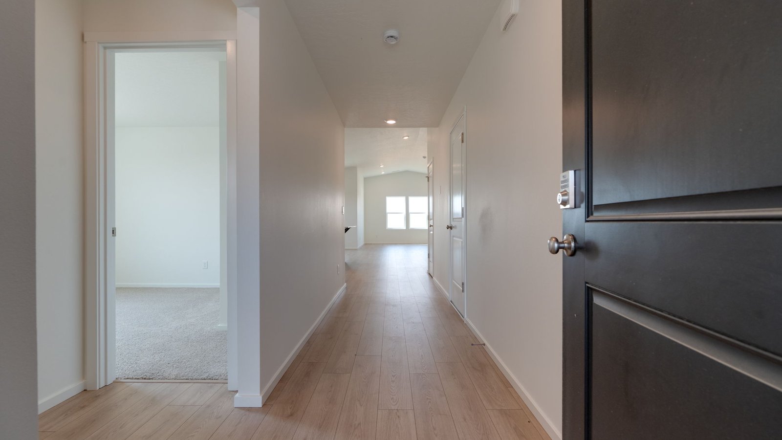 Entryway with a coat closet and laminate flooring