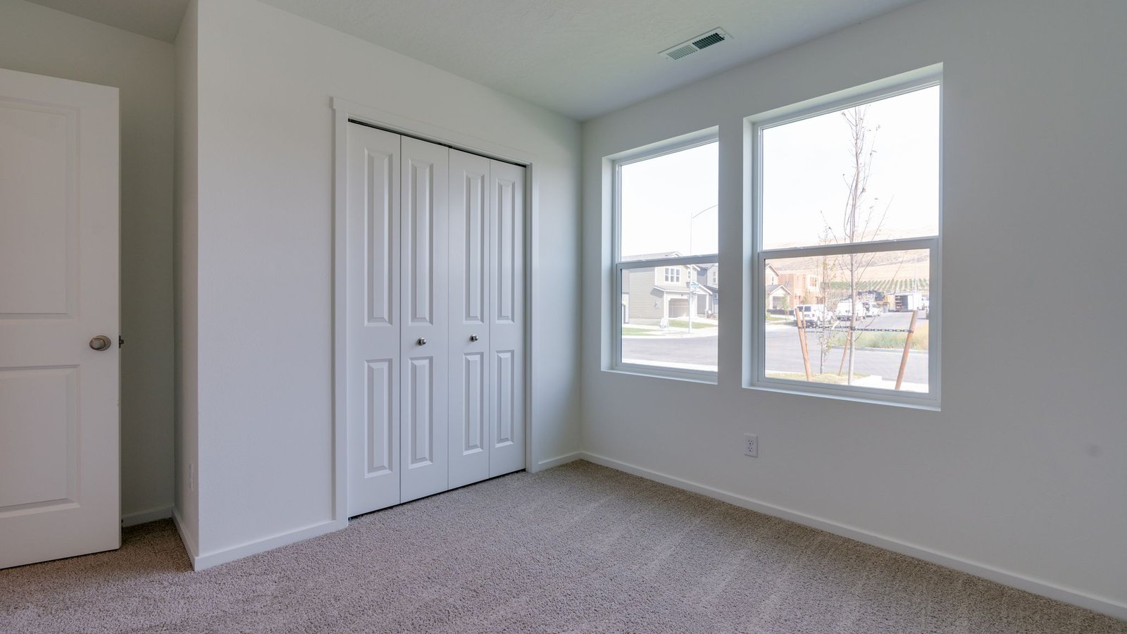 Bedroom with wall-to-wall carpet and a closet