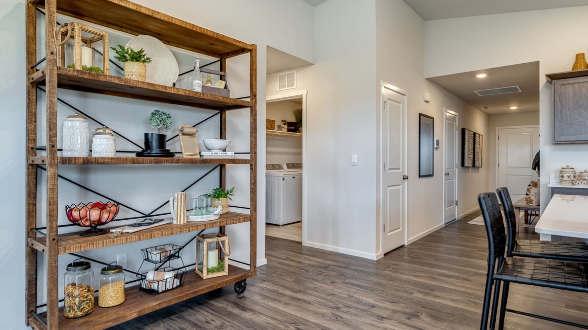 Kitchen with shaker cabinets, quartz counters, stainless steel appliances, pantry, and an island with a breakfast bar