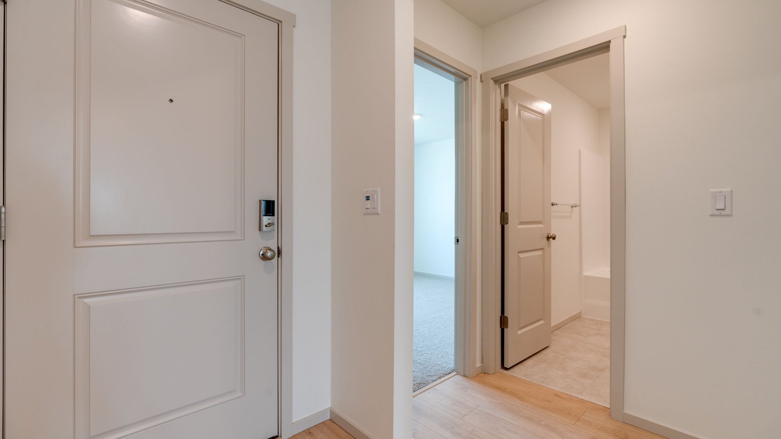 Entryway with a coat closet and laminate flooring