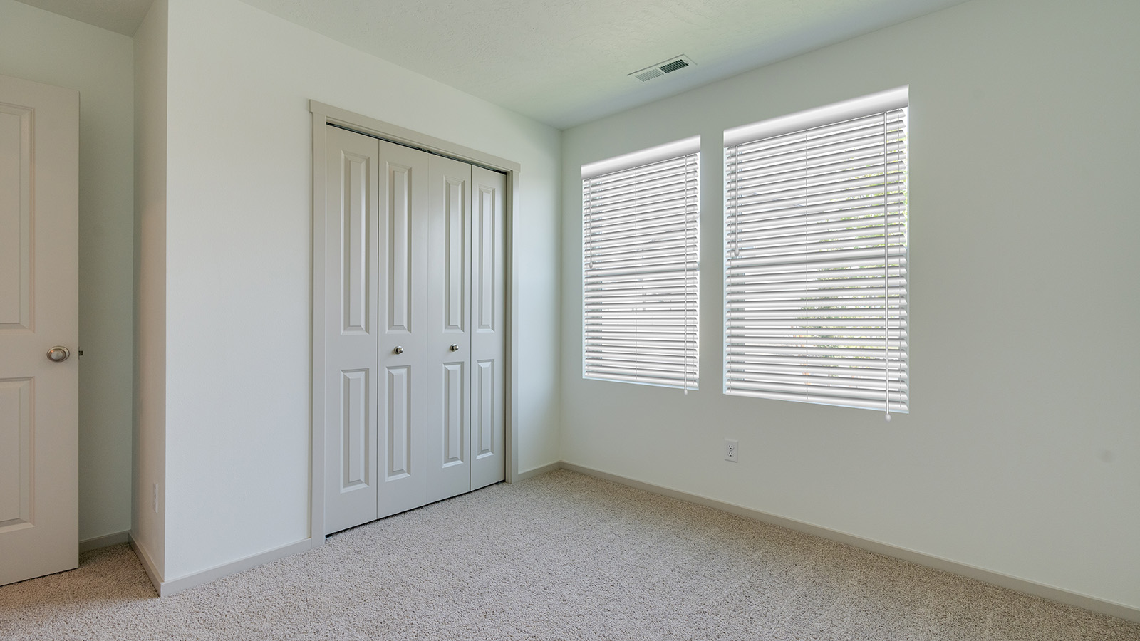 Bedroom with wall-to-wall carpet and a closet