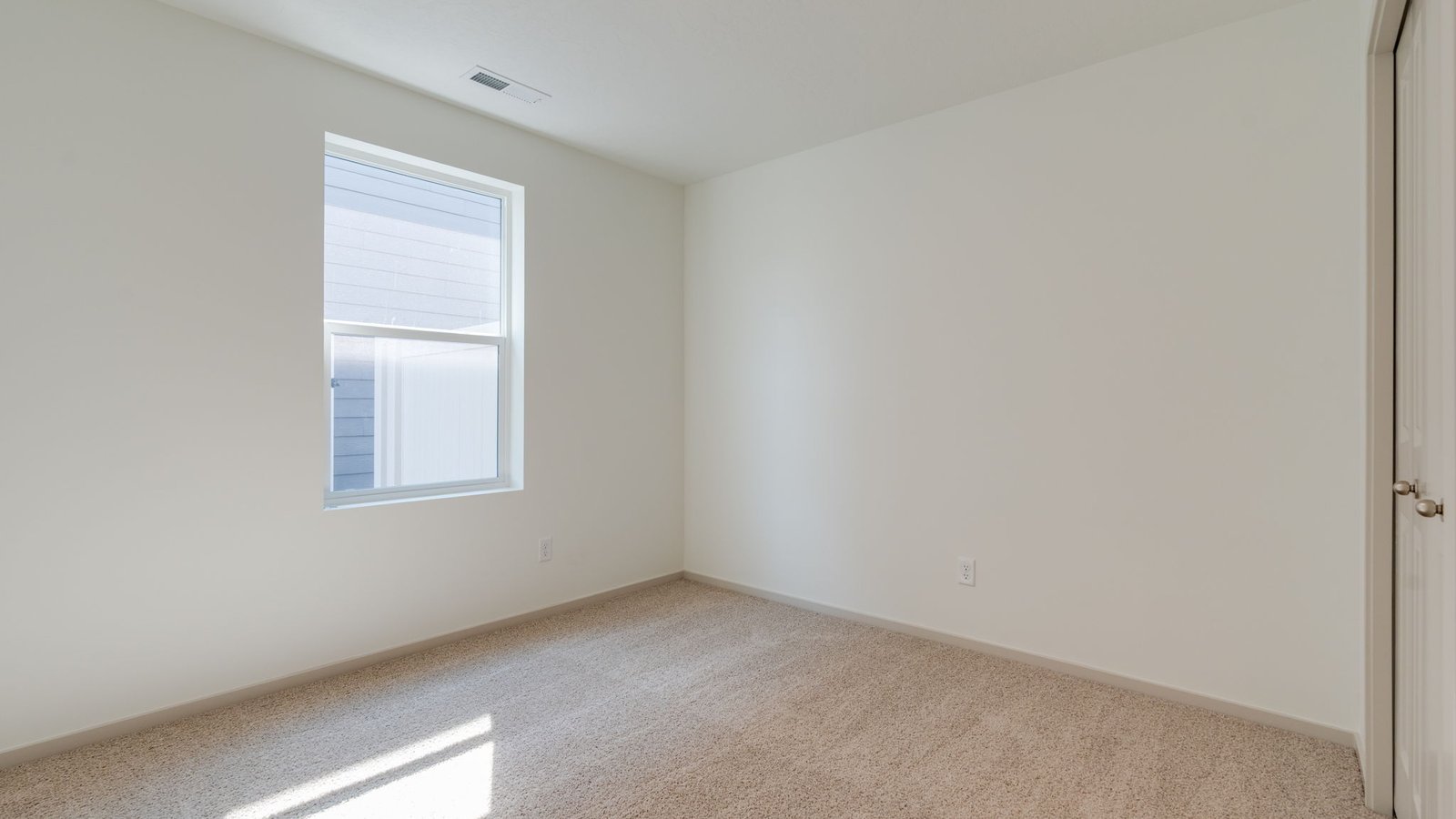 Bedroom with wall-to-wall carpet and a closet