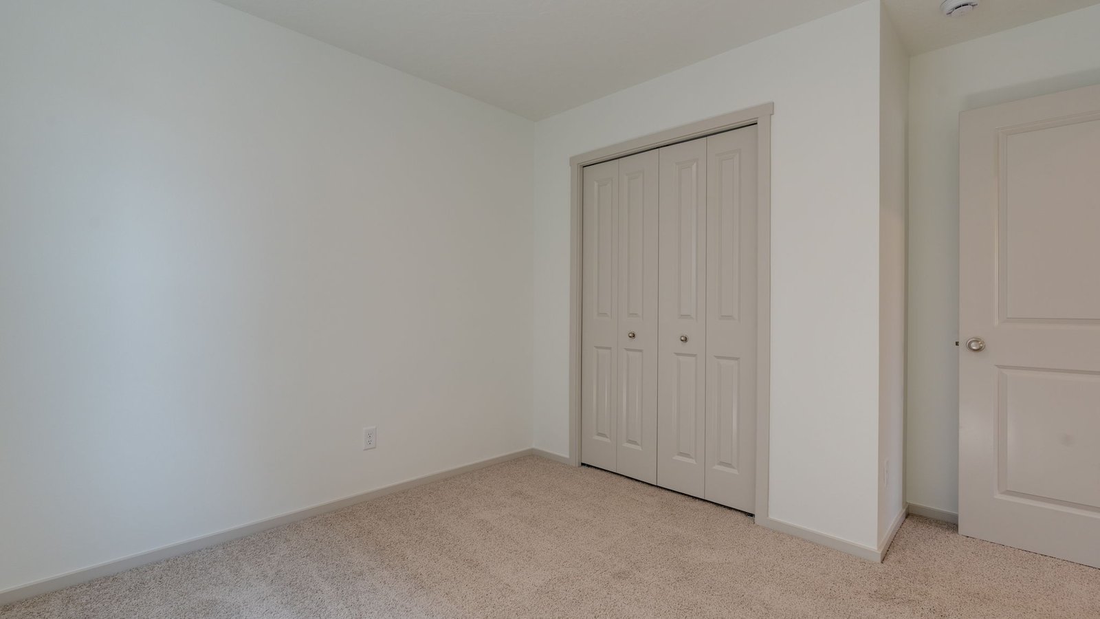 Bedroom with wall-to-wall carpet and a closet