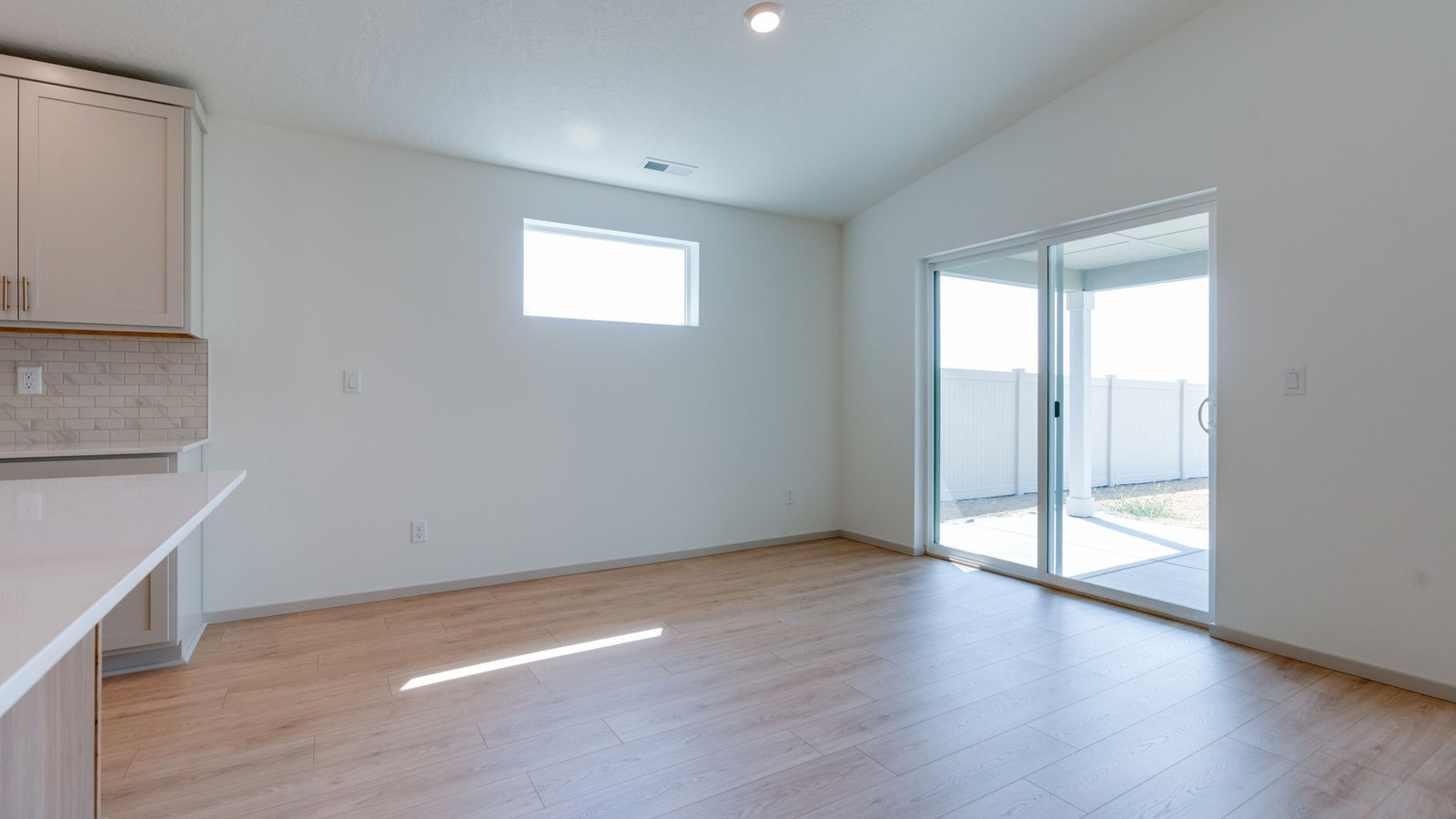 Dining area with a sliding glass door to a fenced backyard