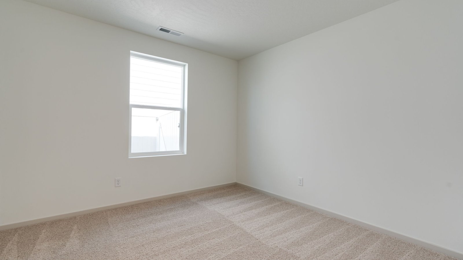 Bedroom with wall-to-wall carpet and a closet