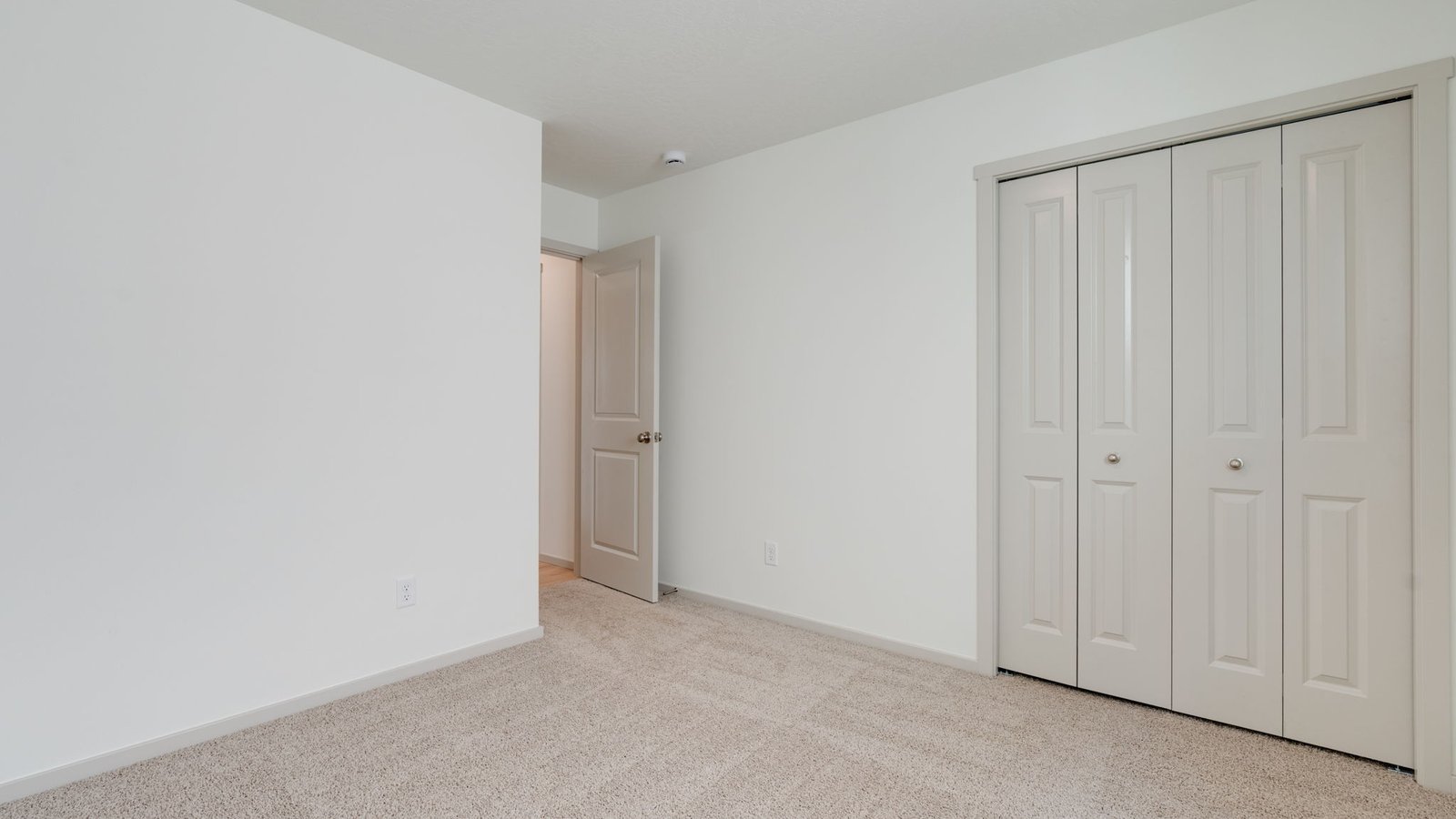 Bedroom with wall-to-wall carpet and a closet
