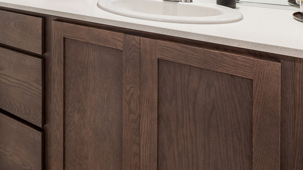 Gray shaker-style kitchen and bathroom cabinets with chrome hardware