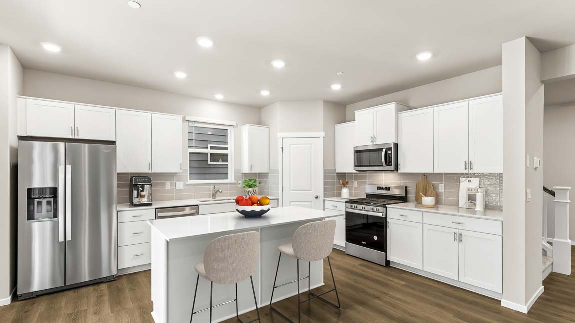 Kitchen with white kitchens and dine in island