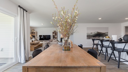 Modern open-concept living and dining area with sliding door