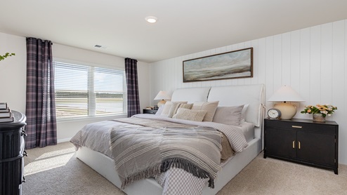 Spacious bedroom one with windows