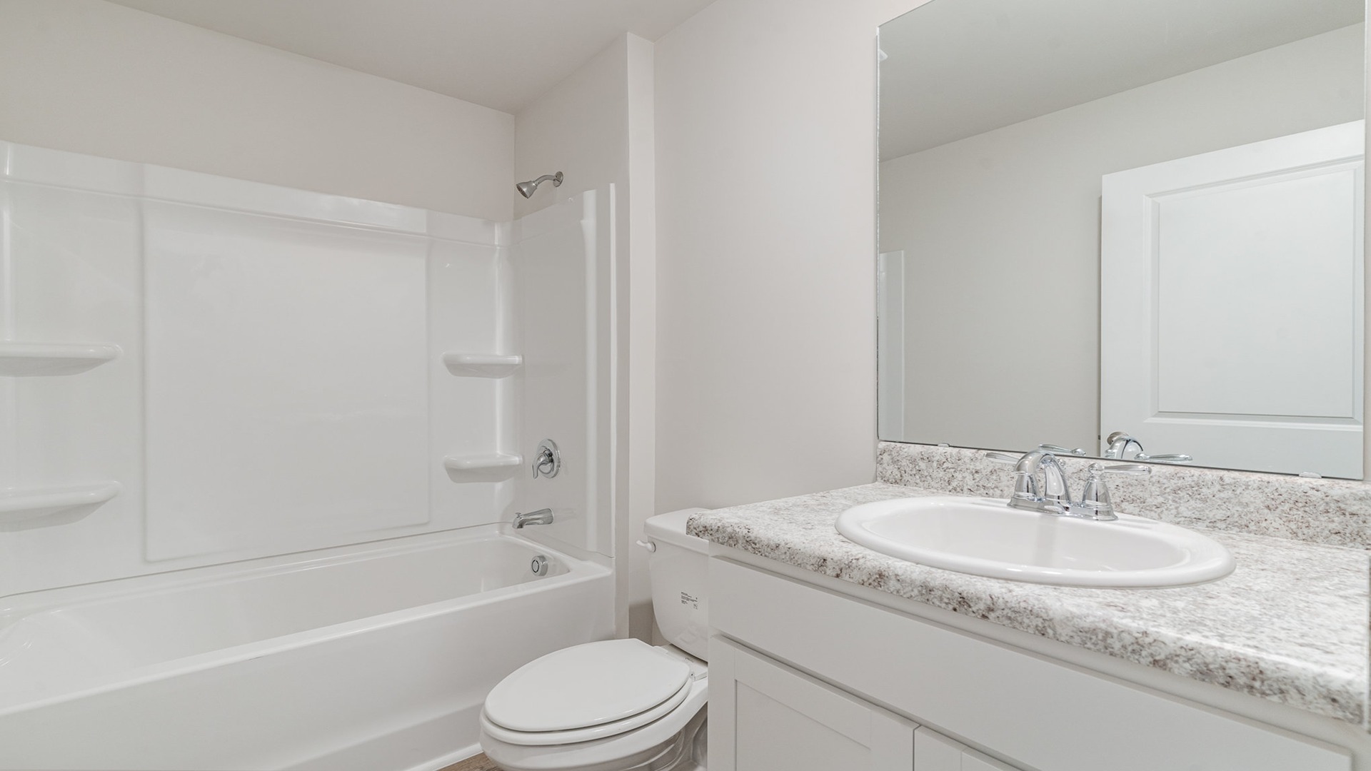 secondary bathroom with white cabinets and a shower tub combo