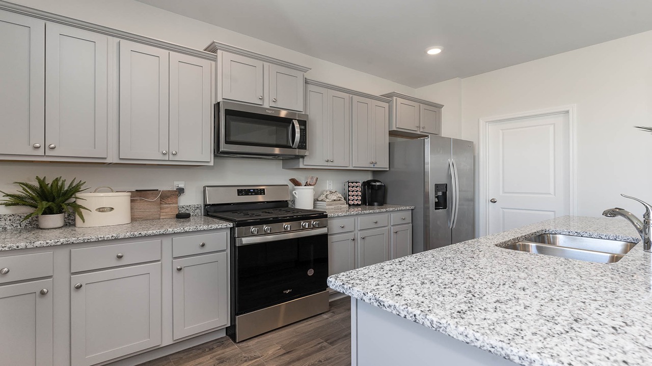 kitchen with gray cabinets and granite countertops