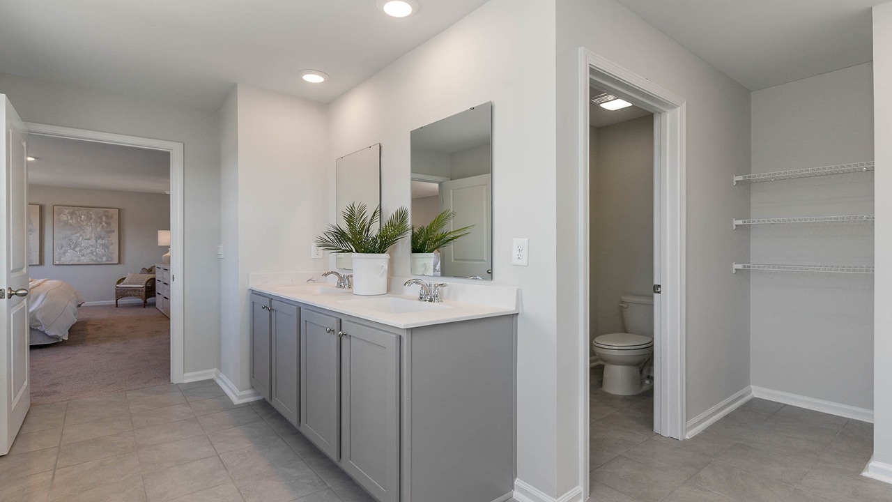primary bathroom with gray vanitiy
