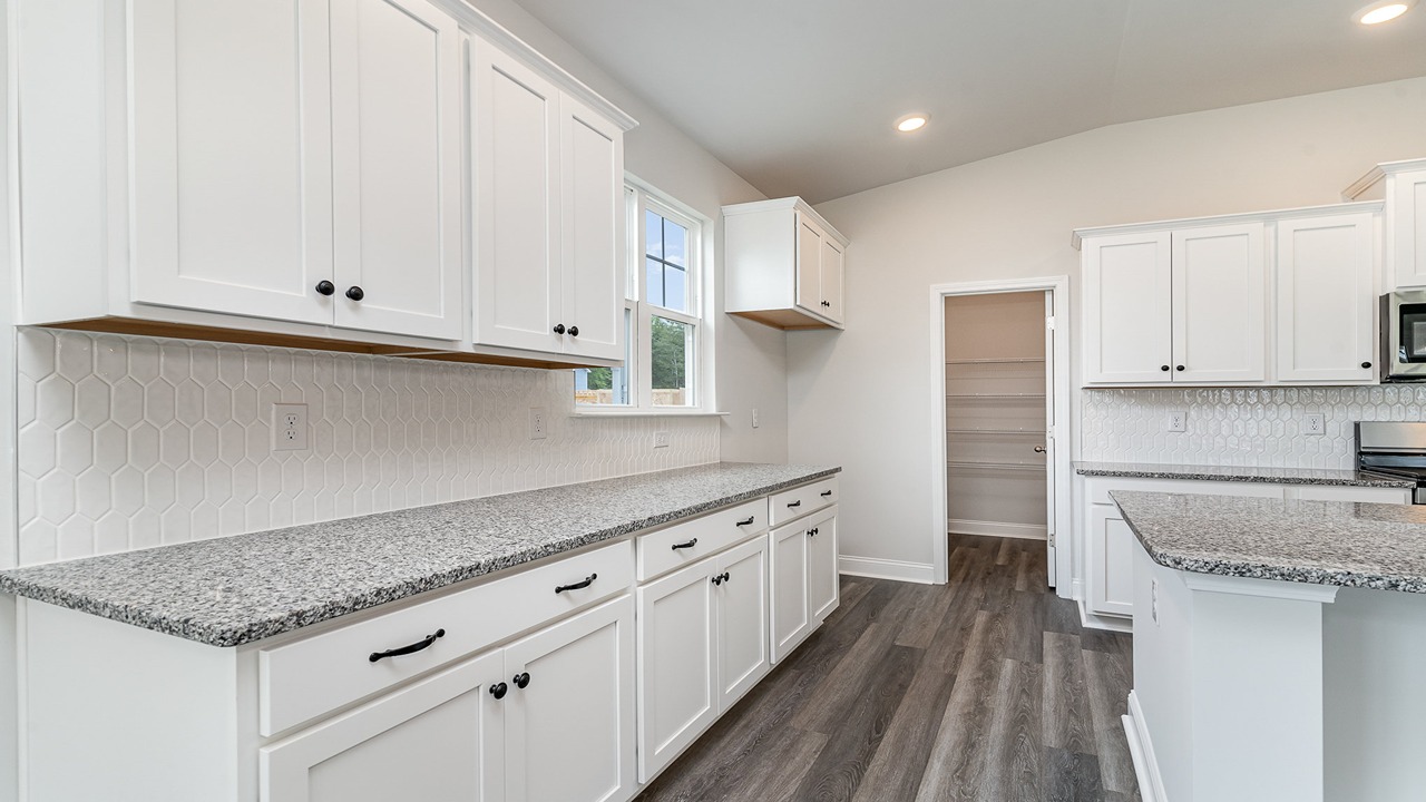 kitchen with white cabinets and granite countertops