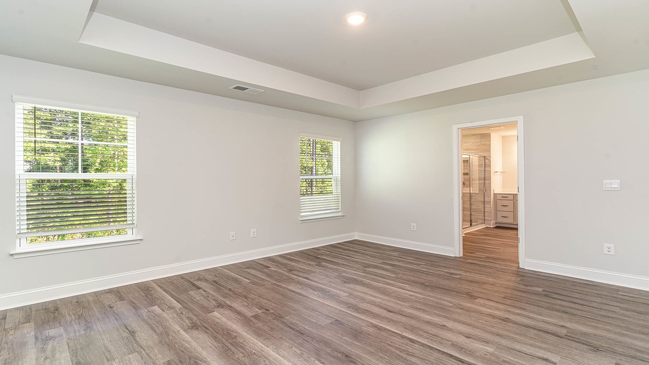 primary bedroom with ray ceilings