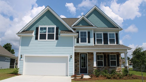 Forrester F exterior with vinyl siding and a 2 car garage
