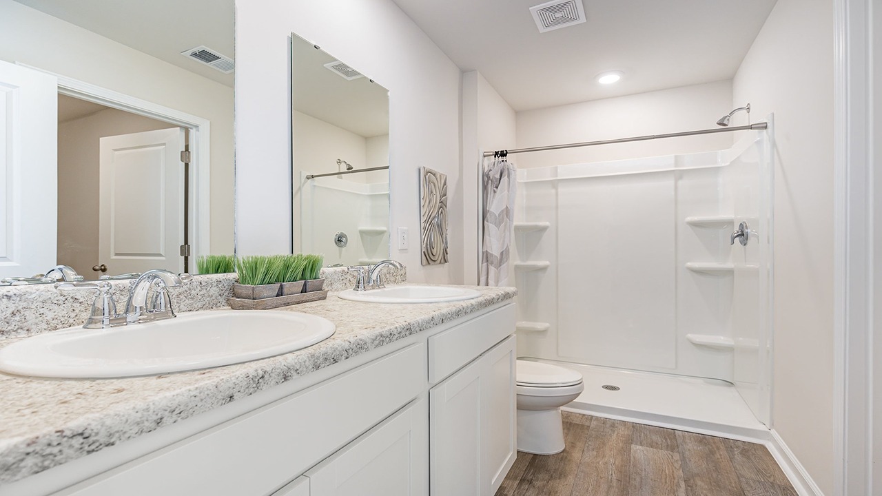 primary bedroom with double vanity