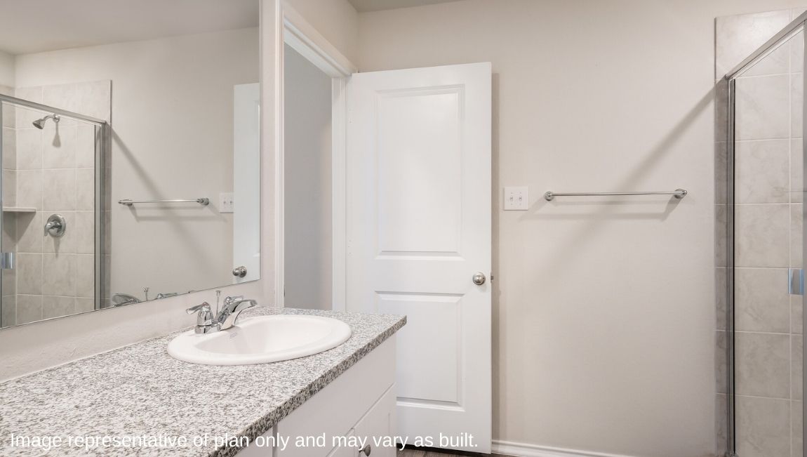 Spacious primary bathroom with plenty of counterspace, single vanity sink and hard surface flooring.
