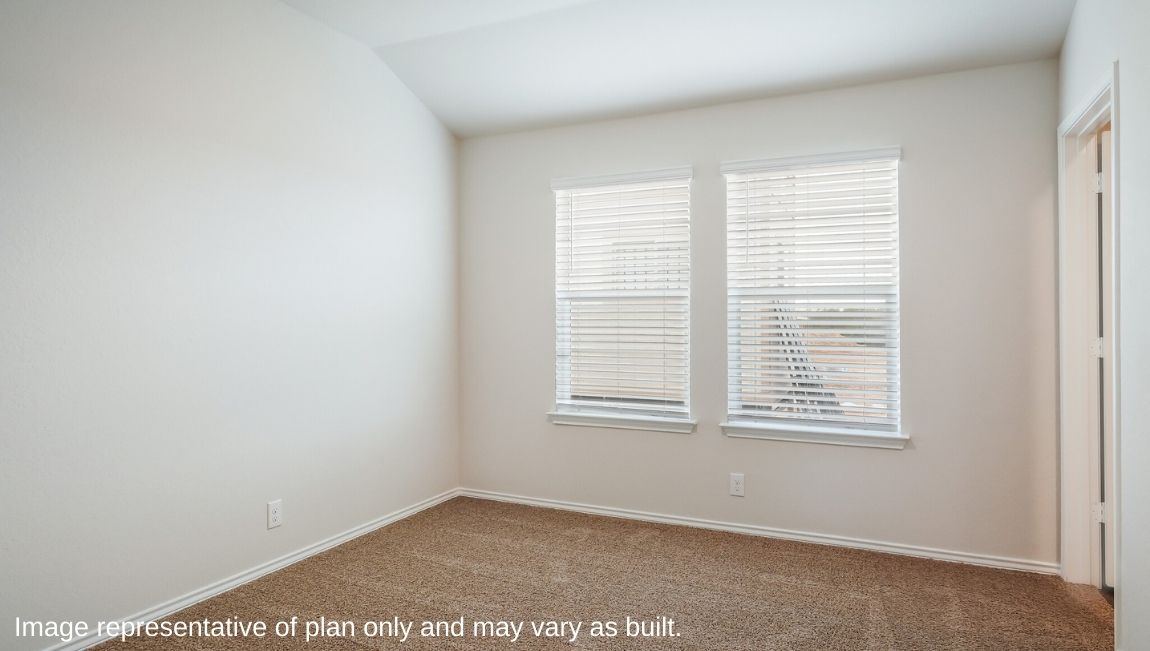 Spacious primary bedroom with ensuite bathroom and walk-in closet.