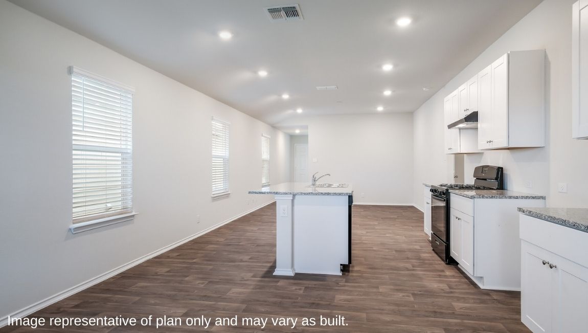 Spacious kitchen facing open-concept living area.