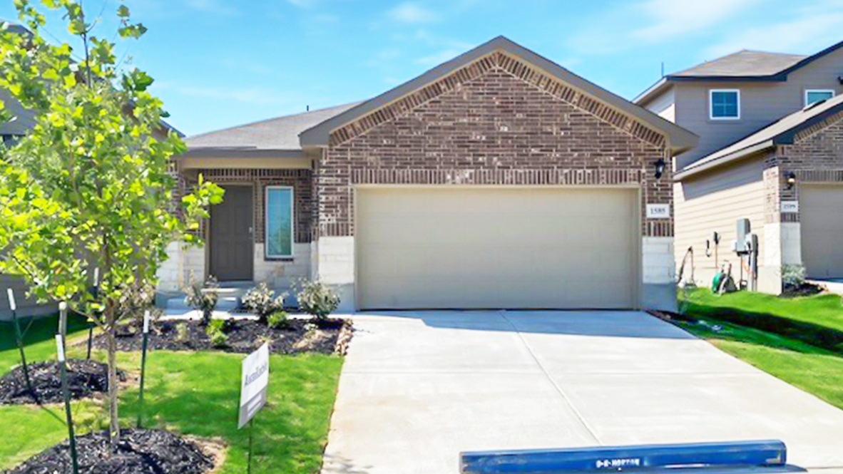 One story home with covered porch, brick and stone front exterior and two car garage.