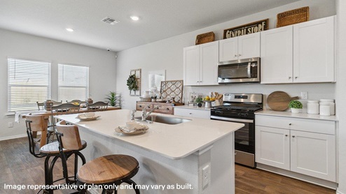 Spacious, open-concept kitchen with island, shaker style cabinets and granite or quartz countertops.