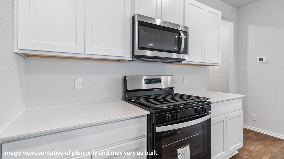 Spacious kitchen with stainless steel appliances and grand island.