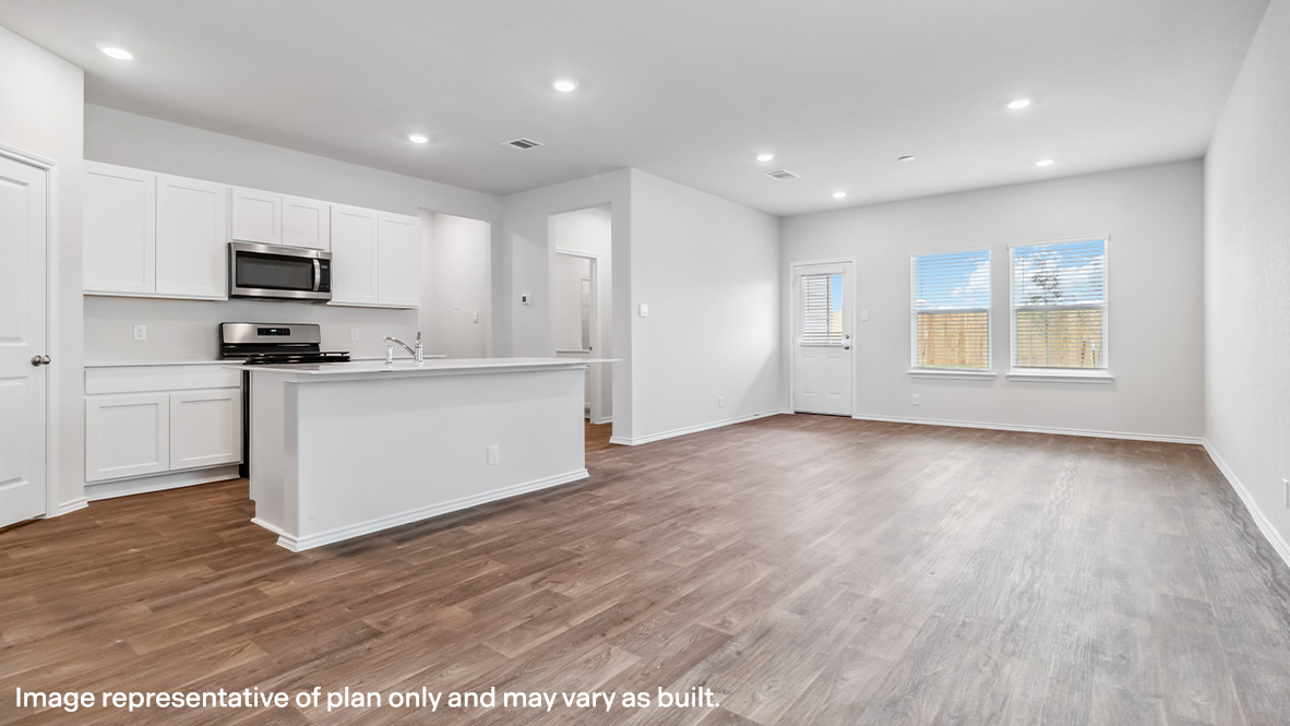 Open-concept living area with hard surface flooring and windows providing plenty of natural light.