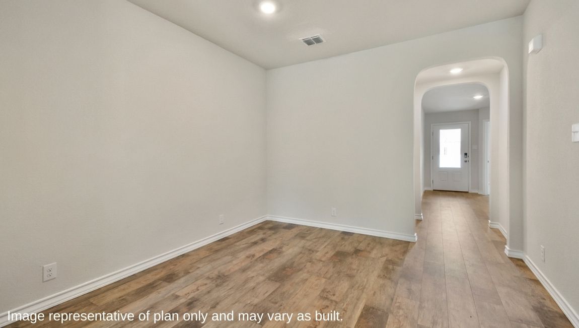 Open-concept dining area with hard surface flooring.