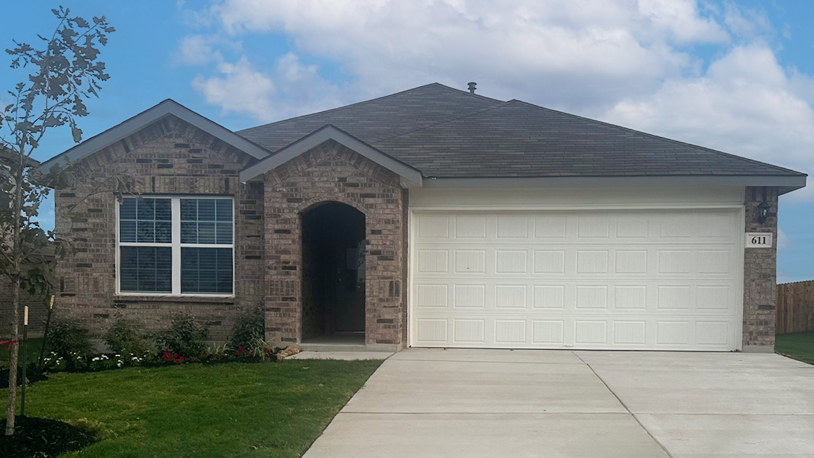 One story home with covered porch, brick front exterior and two car garage.