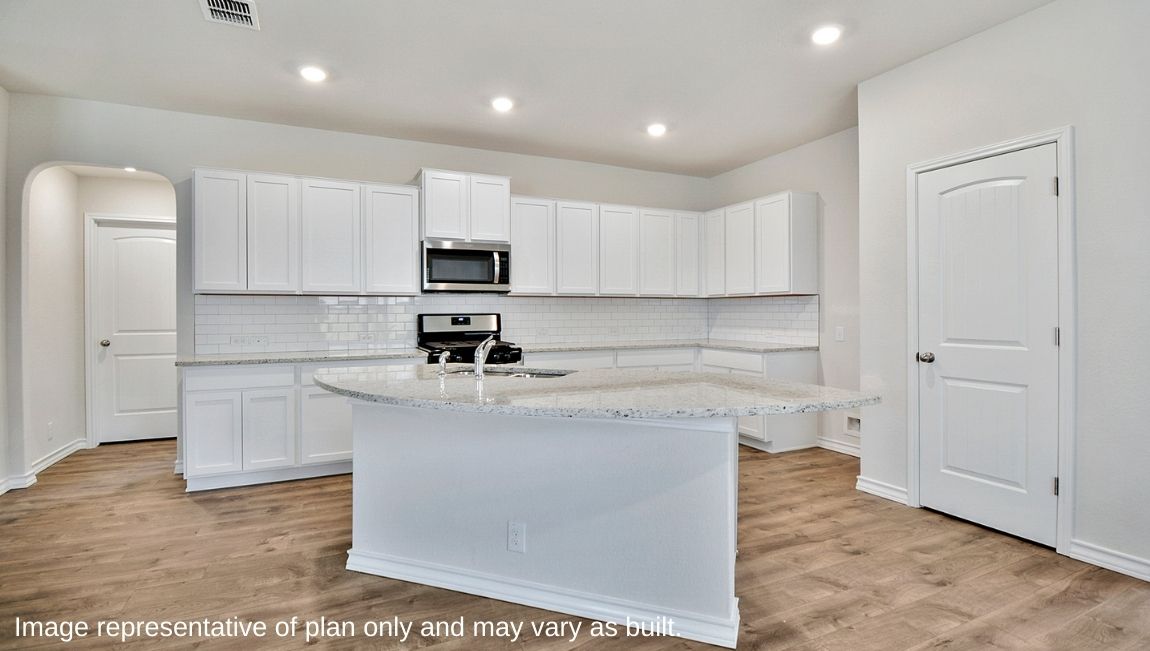 Spacious kitchen with granite or quartz countertops, stainless steel appliances, subway tile backsplash, elongated kitchen island and walk in pantry.