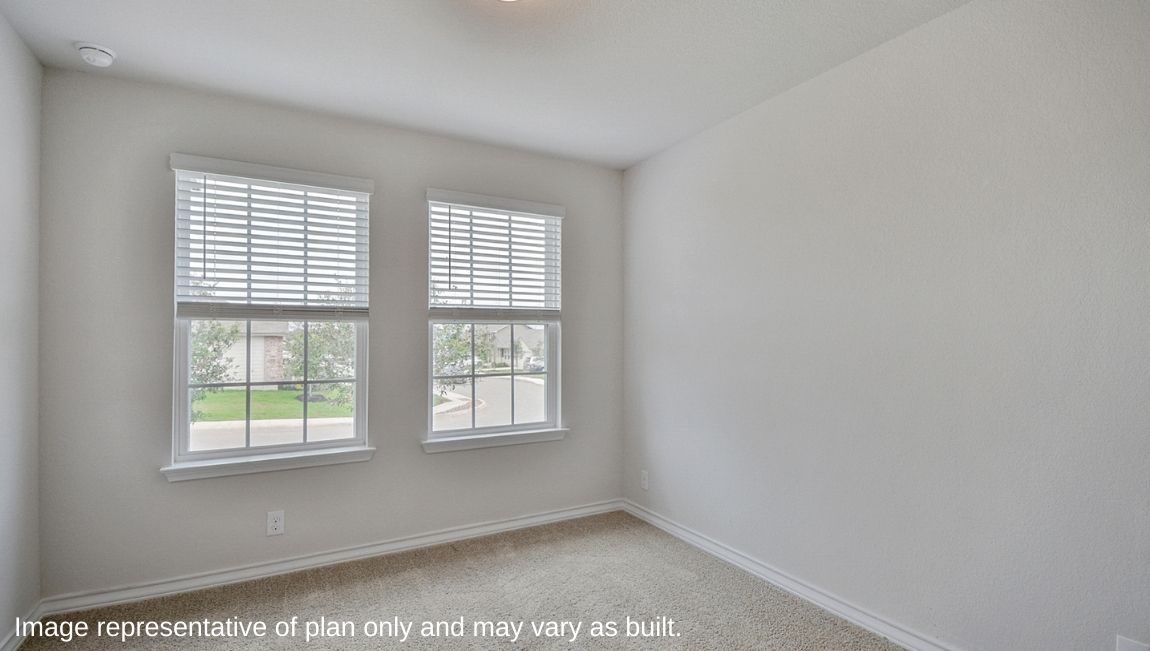 Secondary bedroom with quality carpet, window and closet.
